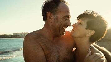 an older couple kissing on the beach video