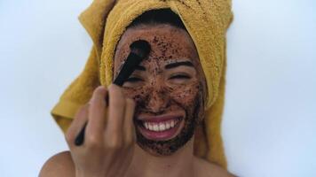 a woman with a face mask with towel on her head video