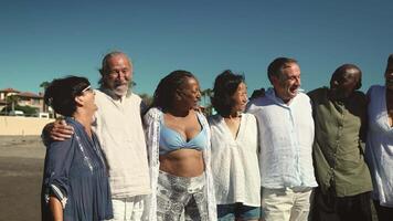 a group of people standing together on the beach video