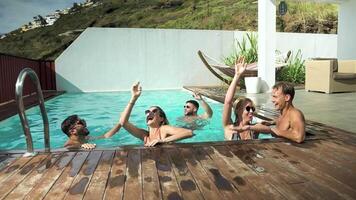 a group of people enjoying a pool party video