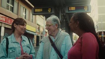 two women and a man talking to each other in a city video