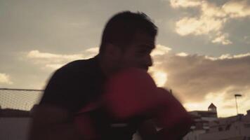 a man in boxing gloves is standing in front of a building video