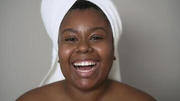 a woman with a towel on her head is smiling video