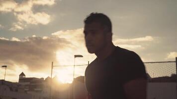 a man in boxing gloves is standing in front of a building video