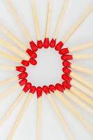 matchstick with a red heart-shaped head on a white background photo