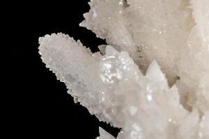 Macro stone Calcite mineral on a black background photo