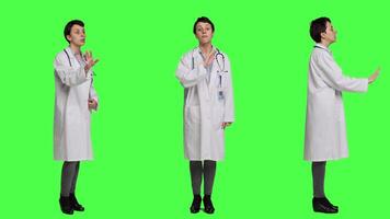 Woman health specialist showing no sign and being furious against greenscreen backdrop, expressing negativity and rage in studio. Angry physician screaming and shouting at people. Camera A. video