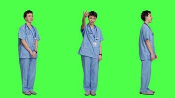 Woman nurse waving hello and inviting people to come closer, calling over patients for checkup examinations against greenscreen. Medical assistant greeting persons and asking them to come. Camera A. video