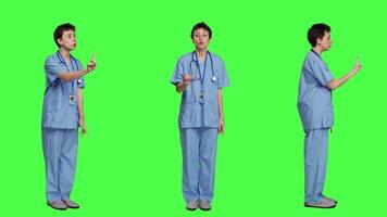 Displeased irritated nurse shouting no and arguing with someone against greenscreen backdrop, showing rage and anger while she wears hospital scrubs. Aggressive medical assistant. Camera A. video