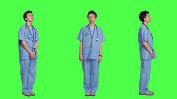 Displeased nurse saying no and sighing against greenscreen backdrop, acting disappointed while she wears blue scrubs. Medical assistant with expertise shows negative gesture, being tired. Camera A. video