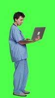 Profile Nurse attending online telemedicine videocall on laptop, talking to patients about disease diagnosis and treatments. Specialist consulting people on internet conference network. Camera A. video