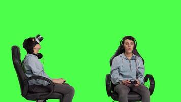 Gamer losing at video games with virtual reality headset and controller, connecting online with her friends to play multiplayer championship. Woman gaming against greenscreen backdrop. Camera B.