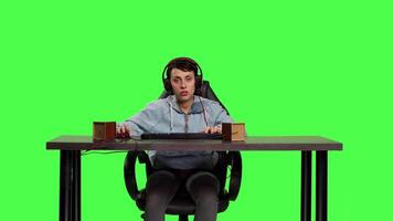 POV woman getting frustrated about losing online gaming tournament, playing video games sitting at desk. Player feeling furious and disappointed with her failure, greenscreen backdrop. Camera B.