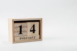 Wooden calendar February 14 on a white background photo