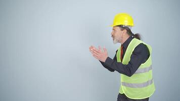 Engineer looking at camera in amazement and making a presentation. video