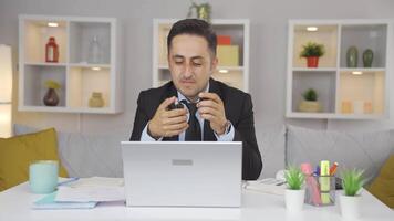 Home office worker sprays perfume on man. video