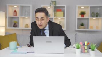 Home office worker man looking at camera curious and confused. video