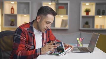 The man looking at the family album is depressed. video