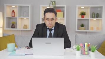 Home office worker man looking nervously at camera. video