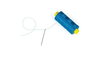 Macro skein of blue thread with a needle on a white background photo