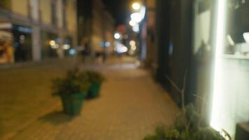 Noche bullicio. borroso 4k imágenes de peatones en ciudad acera video