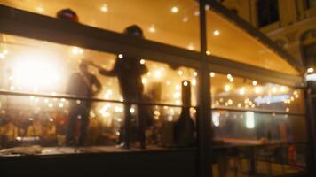 Twilight Serenade. Blurry Video of Musicians Playing in Terrace Bar with Dancing Patrons