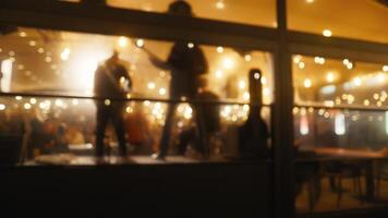 Nighttime Revelry. Blurry Video Shows Musicians and Dancing Crowd in Terrace Bar