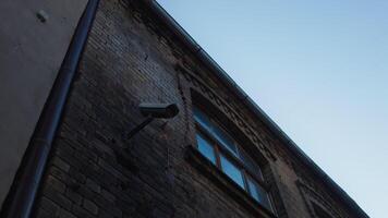 A security camera is fixed on the building facade video