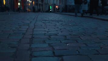 Blurry image of people on cobblestone street at night video