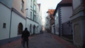 Person walking on cobblestone street in city neighborhood video