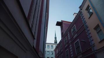 City view with steeple between buildings, looking up at the tower block video