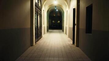 Dark hallway in old building with light at end, creating symmetry and mystery video