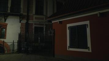 At night, a red building with a black window is illuminated video