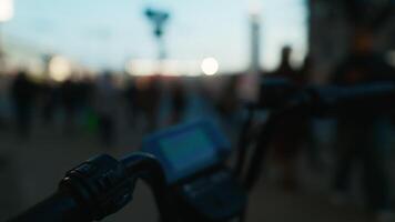 A person riding a bike on a city street, seen through a blurry automotive mirror video