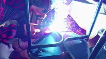 Repairman Welds the Metal Legs of the Chair with Electrode Welding Footage. video