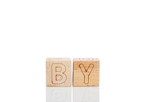 Wooden cubes with letters by on a white background photo