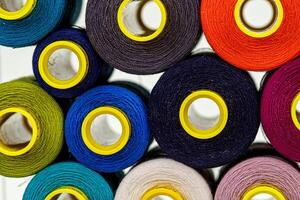 set of multi-colored spools of thread for sewing photo