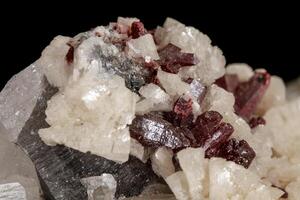 Macro stone Cinnabar dolomite mineral on a black background photo