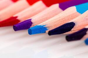 macro multicolored pencils on a white background photo