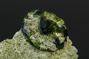 macro mineral stone Andradite on a black background photo