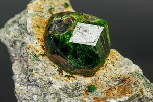 macro mineral stone Andradite on a black background photo