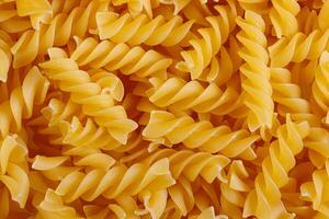 Pasta products in the form of a spiral, texture photo