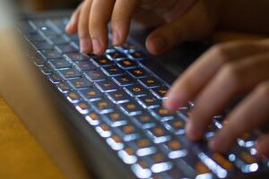 Close up image of hands typing on laptop computer keyboard and surfing the internet at home. Freelancer copywriter working project, typing text, edit something. Remote job concept photo