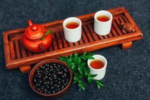 Traditional Chinese tea ceremony with black currant, fruit tea and healthy food. photo