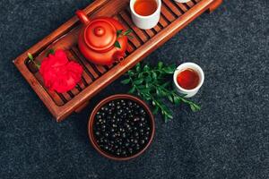 Traditional Chinese tea ceremony with black currant, fruit tea and healthy food. photo