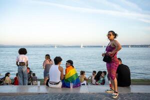 Lisbon, Portugal. 17 June 2023 Gay friends communicate at Pride Parade photo