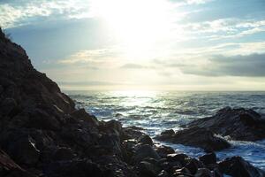 sharped rock in the sea or ocean wave photo