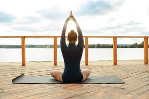 Nature meditation concept. Woman do yoga in lotus position photo