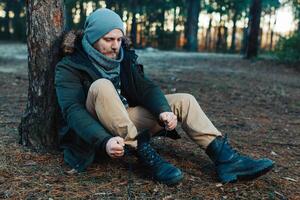 portrait of a bearded hipster tourist man in the woods forest photo