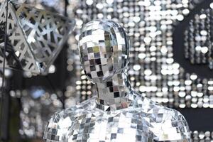 Male mannequin covered with slices of a mirror on a black background mr disco photo